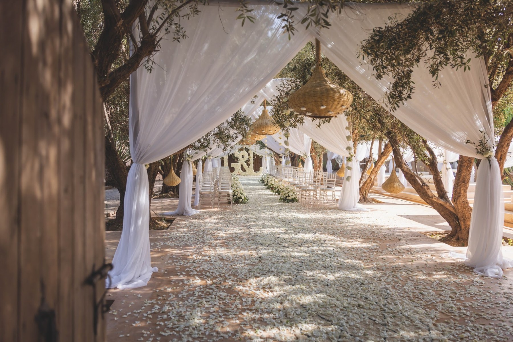 Wedding ceremony beneath a white canopy in the olive grove