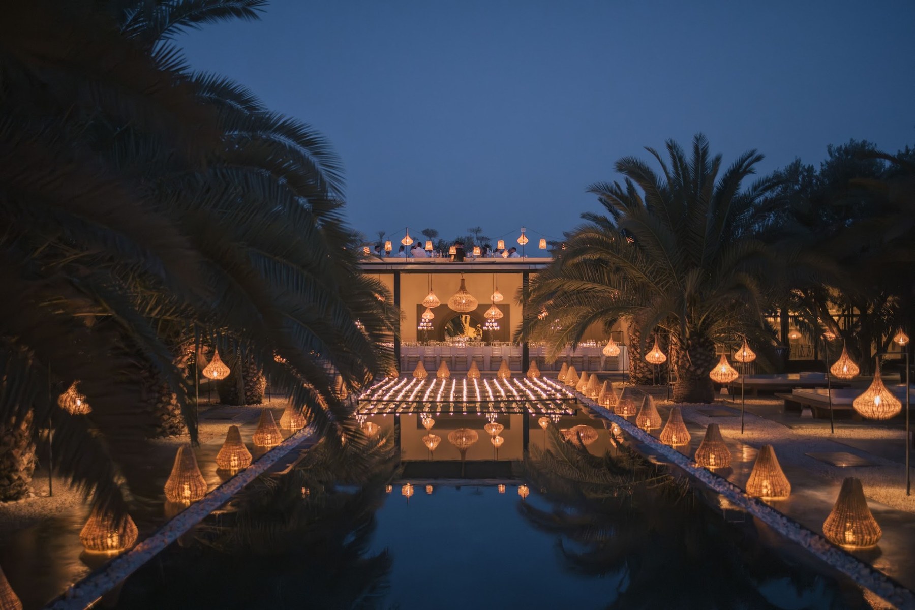 Villa Taj Marrakech lit up for a wedding dinner by the central pool