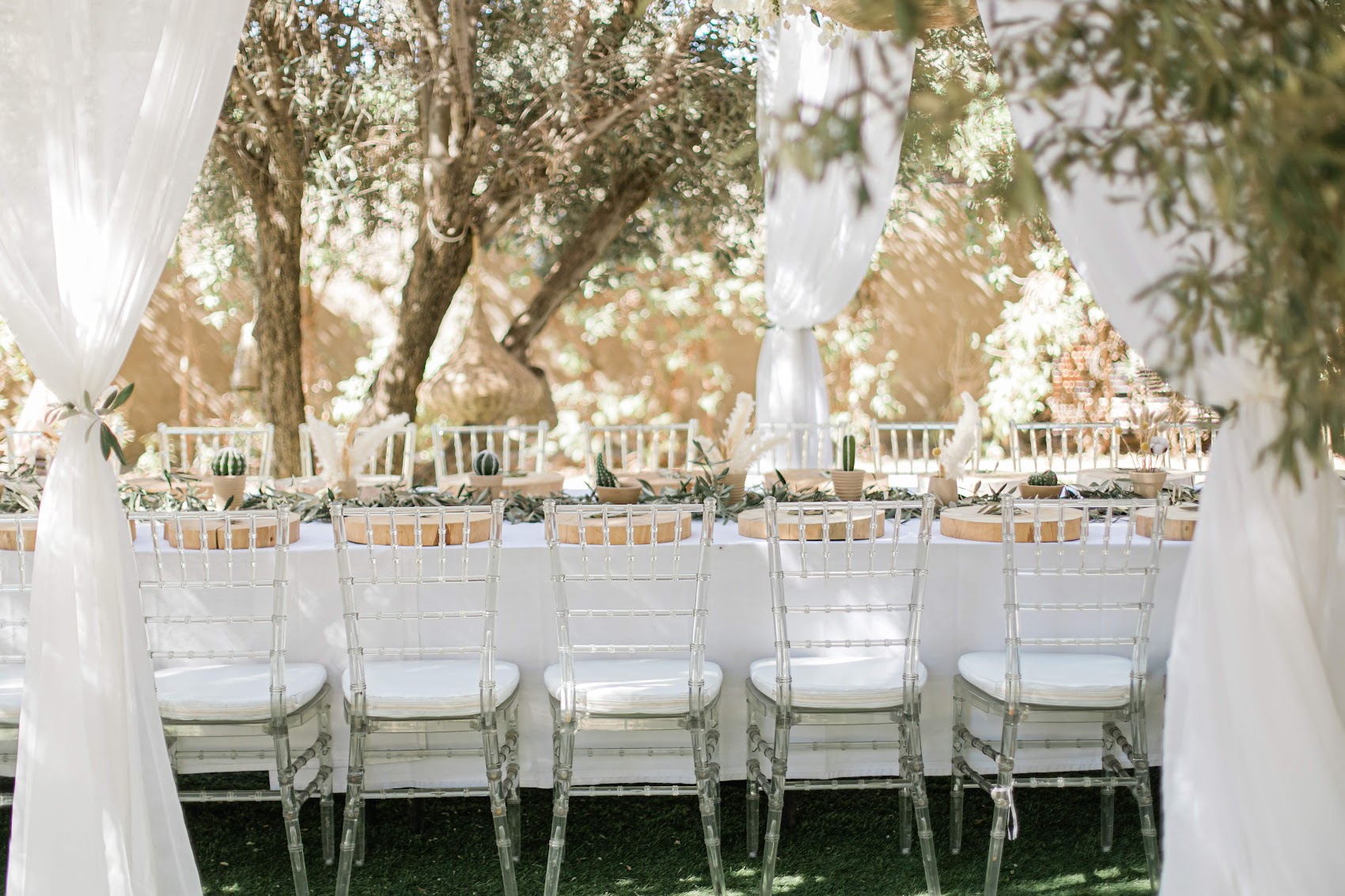 Elegant wedding table beneath olive trees in Marrakech